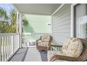 Cozy screened balcony with outdoor seating, perfect for relaxing and enjoying the coastal breeze at 612 N Ocean Blvd. # 103, Surfside Beach, SC 29575