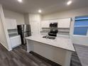 Modern kitchen with granite countertops, stainless steel appliances, and white cabinetry at 620 Muster Field Ct., Conway, SC 29526