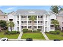 Aerial view of a charming condo building with private balconies and lush landscaping on a sunny day at 637 Waterway Village Blvd. # 13C, Myrtle Beach, SC 29579
