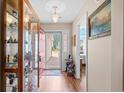 Cozy foyer boasts wood floors, a display cabinet, and natural light at 6478 Royal Pine Dr., Myrtle Beach, SC 29588
