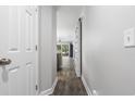 Neutral-toned hallway with wood floors leading to living area with sliding barn door and lots of natural light at 664 Tupelo Ln. # 8A, Longs, SC 29568