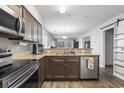 Open kitchen featuring stainless steel appliances, stone countertops, wood floors, and lots of natural light at 664 Tupelo Ln. # 8A, Longs, SC 29568