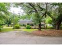 Inviting home with a covered entrance and mature trees in a serene setting at 704 N North Congdon St., Georgetown, SC 29440