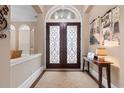Inviting front foyer boasts double doors with decorative glass and a neutral color palette at 7253 Seville Dr., Myrtle Beach, SC 29572