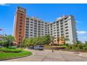 Beautiful exterior of a multi-story condominium complex with manicured landscaping and a circular driveway entrance at 8121 Amalfi Pl. # 7-604, Myrtle Beach, SC 29572