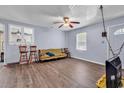 Inviting living room with wood-look floors, a ceiling fan, and natural light from the windows at 1104 Ragin St., Myrtle Beach, SC 29577