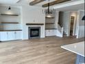 Inviting living room with fireplace, built-ins, hardwood floors, and views into the kitchen at 1142 Fiddlehead Way, Myrtle Beach, SC 29579