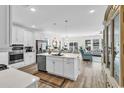 Open-concept kitchen with a large island, stainless steel appliances, and seamless flow into the dining and living areas at 1340 Jolly Roger Dr., North Myrtle Beach, SC 29582