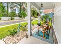 Inviting front porch with rocking chairs and decorative peacock statues amidst lush landscaping and stone accents at 1340 Jolly Roger Dr., North Myrtle Beach, SC 29582