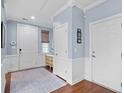 Bright foyer with hardwood floors, neutral walls, and ample natural light from the window at 1444 Thames Ct., Myrtle Beach, SC 29577