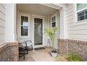Inviting front porch features stylish brick accents, a cozy seating area, and decorative plant at 1444 Thames Ct., Myrtle Beach, SC 29577