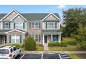 Well-maintained townhome featuring a blend of brick and siding, accented by green shutters and manicured landscaping at 151 Chenoa Dr. # 35-F, Murrells Inlet, SC 29576