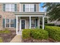 Inviting covered front porch with white columns and green shutters that adds to the charm of this townhouse at 151 Chenoa Dr. # 35-F, Murrells Inlet, SC 29576