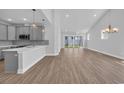 Bright living space featuring gray walls, wood floors, and sliding glass doors to the outside at 1533 Coastal Cove Ln, Calabash, NC 28467