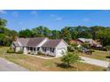 Aerial view of a lovely single-story home featuring a lush green yard and a cozy front porch at 1566 Bessent Ave., Little River, SC 29566