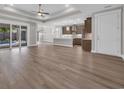 Open-concept living space featuring sleek wood flooring, recessed lighting, and a view to the pool at 1936 Indigo Cove Ln, Calabash, NC 28467