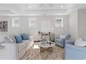 Cozy living room featuring neutral decor, hardwood floors, and large windows for natural light at 1946 Indigo Cove Ln, Calabash, NC 28467