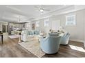 Open-concept living room showcases hardwood floors, natural light, and stylish, neutral decor at 1946 Indigo Cove Ln, Calabash, NC 28467