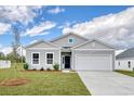 Attractive single-story home with a two-car garage, lush lawn, and landscaped front yard at 200 Lister St, Conway, SC 29526