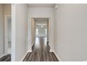 Bright hallway featuring stylish hard floors, neutral walls, and an open view to the living area at 200 Lister St, Conway, SC 29526