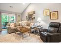 Cozy living room features a comfortable sofa and a decorative gallery wall at 2016 Willow Run Dr. # B, Little River, SC 29566