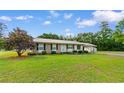 Well-maintained single-story home features brick accents, metal roof and manicured front lawn at 2096 Golden Leaf Rd., Galivants Ferry, SC 29544