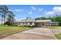 Inviting single-story home with a metal roof, brick accents and a covered carport on a well-sized lot at 2096 Golden Leaf Rd., Galivants Ferry, SC 29544