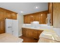 Traditional kitchen with wood cabinets, white appliances and hardwood floors at 2096 Golden Leaf Rd., Galivants Ferry, SC 29544