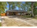 Single-story brick home with spacious driveway, and attractive landscaping at 2519 Reta St., Conway, SC 29526