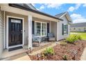 Inviting front porch with rocking chairs and a small table, perfect for relaxing outside at 2521 Wise Rd., Conway, SC 29526
