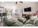 Spacious living room featuring a comfortable sectional sofa, vaulted ceiling, and wood-look flooring at 2521 Wise Rd., Conway, SC 29526