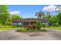 Beautiful home with blue siding, front yard landscaping, and a circular driveway at 2650 Highway 554, Loris, SC 29569
