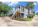 Charming home with a wooden staircase leading to the front porch, complemented by lush landscaping at 299 Lake Arrowhead Rd., Myrtle Beach, SC 29572
