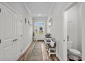Neutral entryway featuring light walls, a hall table, and a half-bath at 322 Canyon Dr., Conway, SC 29526