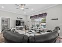 Comfortable living room featuring a large window view of the pool and a large television at 322 Canyon Dr., Conway, SC 29526