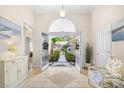 Bright foyer with tiled flooring, arched doorway and views through the front door to exterior landscaping at 4 Stillwater Ct., Murrells Inlet, SC 29576