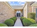Inviting front entryway featuring double doors, lush landscaping, and a walkway leading to the entrance at 4 Stillwater Ct., Murrells Inlet, SC 29576