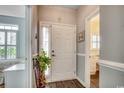 Inviting foyer with wood-look flooring and a view into a bedroom and kitchen, creating a warm welcome at 4294 Rivergate Ln., Little River, SC 29566