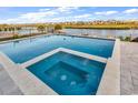 Gorgeous swimming pool and jacuzzi offer a relaxing outdoor experience with serene water views in the background at 437 Saint Julian Ln., Myrtle Beach, SC 29579