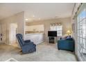 Open concept living space with a view of the kitchen, a comfortable recliner, and sliding glass doors at 4507 Sweetwater Blvd. # 4507, Murrells Inlet, SC 29576