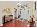 Inviting foyer with hardwood floors, a chandelier, and a decorative console table at 4803 Bucks Bluff Dr., North Myrtle Beach, SC 29582