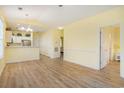 Open-concept living area flows into a kitchen; features include light wood flooring and paint at 488 River Oaks Dr. # 61N, Myrtle Beach, SC 29579