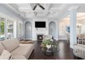 Living room with a fireplace, coffered ceiling, ceiling fan and large windows at 5032 Middleton View Dr., Myrtle Beach, SC 29579