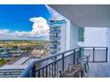 Condo balcony with chairs overlooking an expansive skyline and building exterior at 504 N Ocean Blvd. # 1711, Myrtle Beach, SC 29577