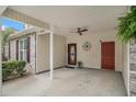 The carport features a ceiling fan, two doors, and a decorative clock against a neutral color scheme at 511 Colonial Trace Dr. # 7-C, Longs, SC 29568