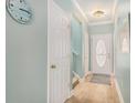 The foyer features a decorative front door, wood-look floors, and serene light blue walls at 511 Colonial Trace Dr. # 7-C, Longs, SC 29568