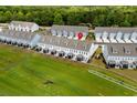 Aerial view of community featuring modern townhomes, landscaping, and green space at 5127 Double Eagle Way # 11, North Myrtle Beach, SC 29582