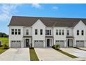 Inviting townhomes featuring modern architecture, complemented by lush green lawns and vibrant landscaping at 5127 Double Eagle Way # 11, North Myrtle Beach, SC 29582
