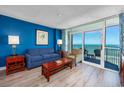 Cozy living room with ocean views, comfortable seating, and access to a private balcony at 5300 N Ocean Blvd. # 1208, Myrtle Beach, SC 29572