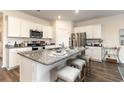 Stylish kitchen featuring granite countertops, a center island, and stainless steel appliances at 559 Strawberry Field Way, Galivants Ferry, SC 29544